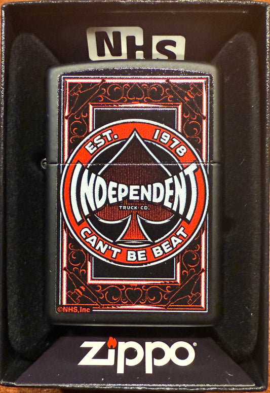 A Zippo lighter with a black matte finish featuring the Independent Spade logo in red and white, displayed in its packaging with the text 'NHS' on the top.