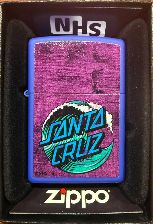 A Zippo lighter with a blue background featuring the Santa Cruz Skateboards iconic wave graphic, presented in a gift box with the Zippo logo.